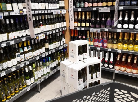 In-store liquor shopping, wine aisle, wine bottles, trolley, cart